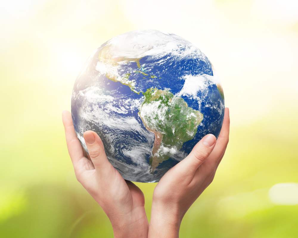 zoomed in picture of a persons hands holding earth (planet).