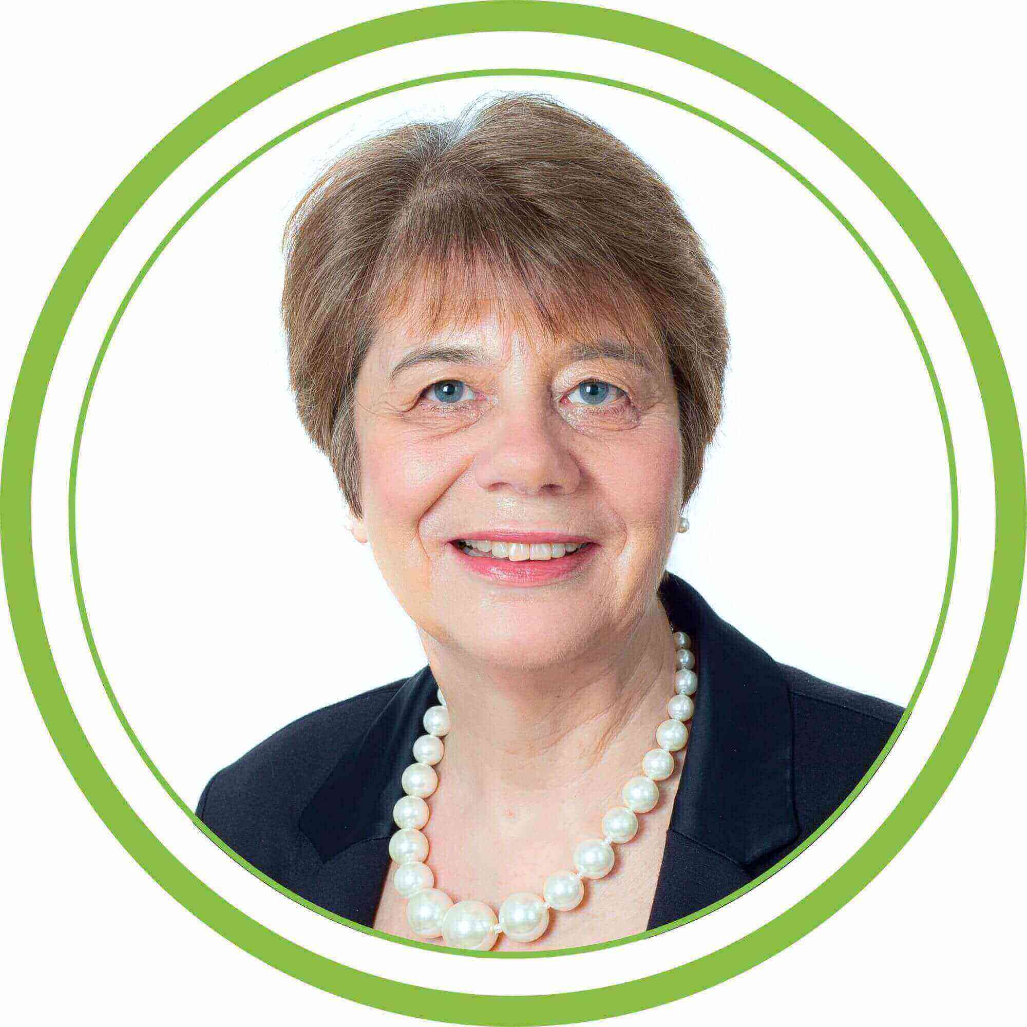 Angie, one of our trainers. A white background and a green circular frame.