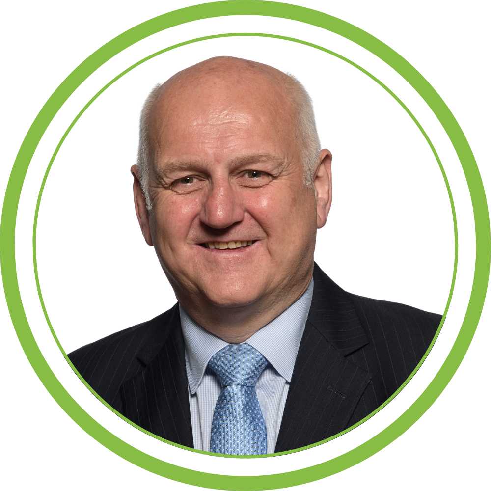 A picture of one of our trainers, white background with a green circular frame.