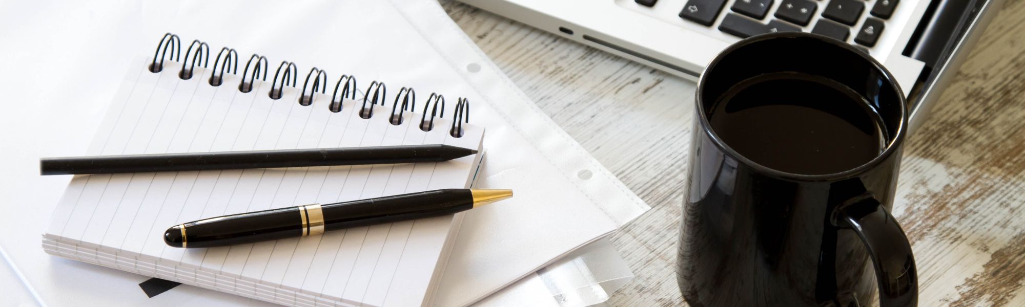 pen, pencil, notebook, cup and laptop
